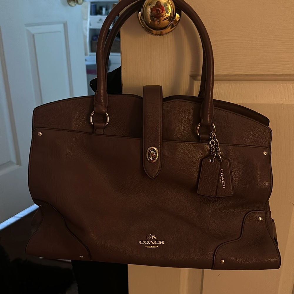 Coach handbag purple only used twice. comes with over the shoulder strap.